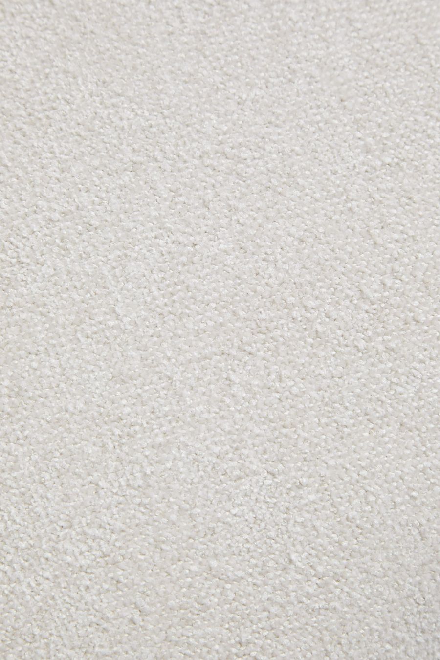 Gros plan du tissu chenille crème, aux petites bouclettes serrées et régulières.