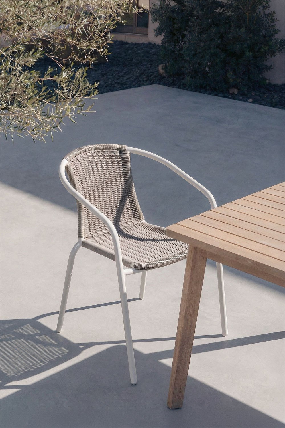 Stackable garden chair with armrests in steel and synthetic rattan Kalymana, gallery image 1