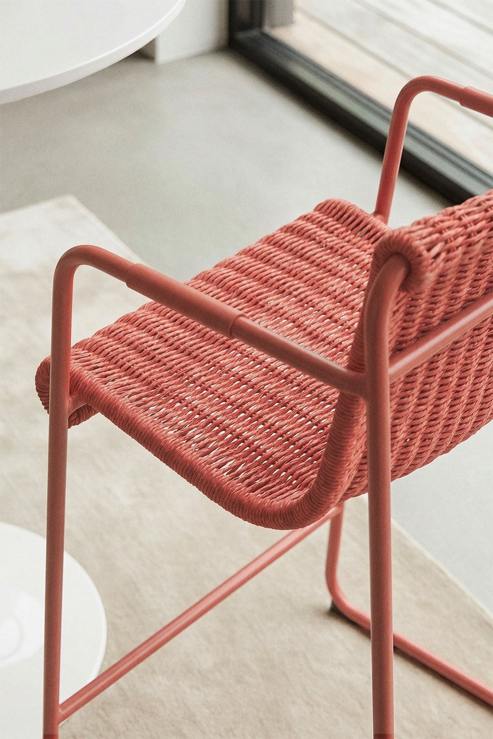 Stackable high stool with armrests in synthetic rattan and steel Revia, gallery image 2