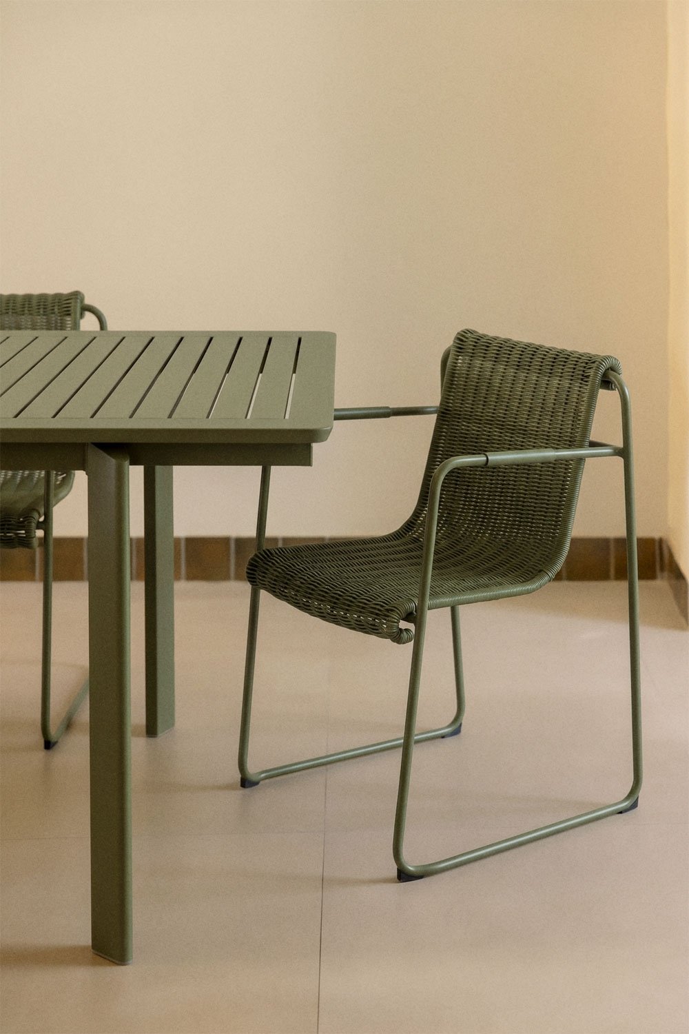 Stackable dining chair with armrests in synthetic rattan and steel Revia, gallery image 1