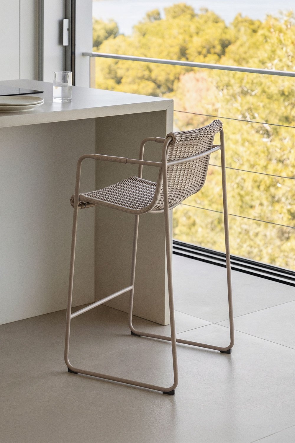 Stackable high stool with armrests in synthetic rattan and steel Revia, gallery image 1